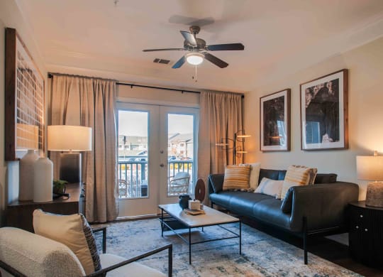 a living room with a couch coffee table and a ceiling fan