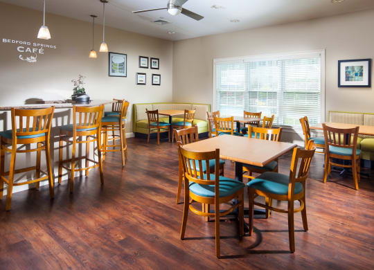 a dining room with tables and chairs and a couch