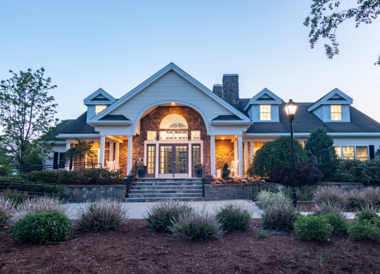 the front of a house at night with the front porch lit