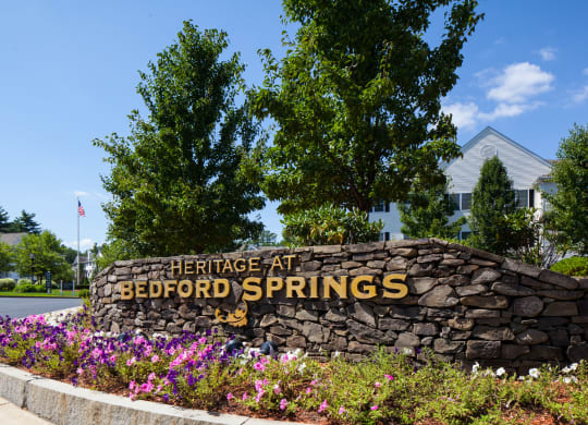 a stone wall with a sign that reads heritage