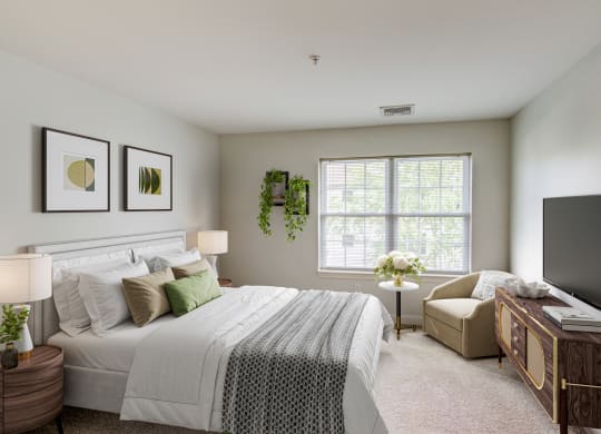 a bedroom with a bed and a chair and a television