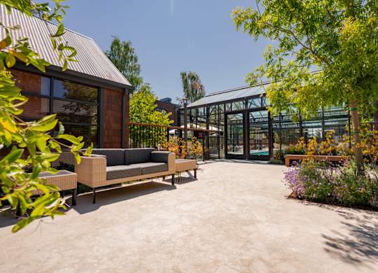 Outdoor courtyard with seating and garden surroundings