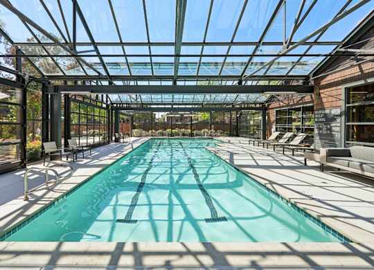 Resort-style pool with clear water and surrounding seating