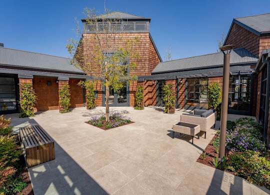 Pool house exterior with landscaped surroundings