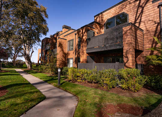 Apartment grounds with lush greenery and landscaped paths at Indian Creek in Redwood City