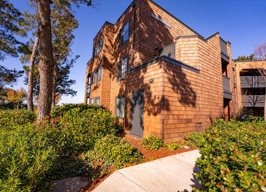 Apartment grounds with lush greenery and landscaped paths at Indian Creek in Redwood City