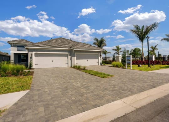 a house with a driveway and a garage door at Marisol, Bradenton, FL 34211
