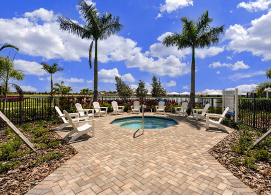 the pool is surrounded by chairs and palm trees at Marisol, Bradenton 34211