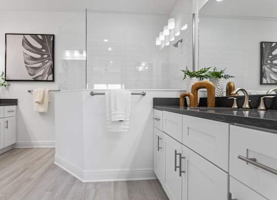 A bathroom with a white tub and a plant on the counter at Marisol in Lakewood Ranch, FL