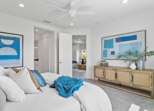 A bedroom with a large bed and a ceiling fan at Marisol in Lakewood Ranch, FL