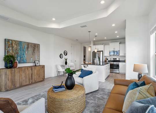 A modern living room with a white sofa and a wooden coffee table at Marisol in Lakewood Ranch, FL
