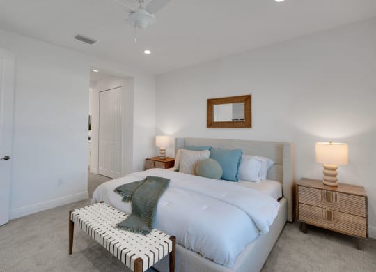 a white bedroom with a white bed and a white chair at Marisol, Bradenton Florida 34211
