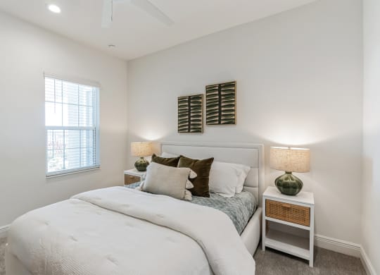 a bedroom with a bed and two nightstands and a window at Marisol, Bradenton FL