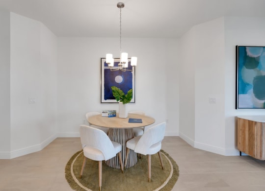 a dining room with a table and chairs and a painting on the wall at Marisol, Bradenton Florida