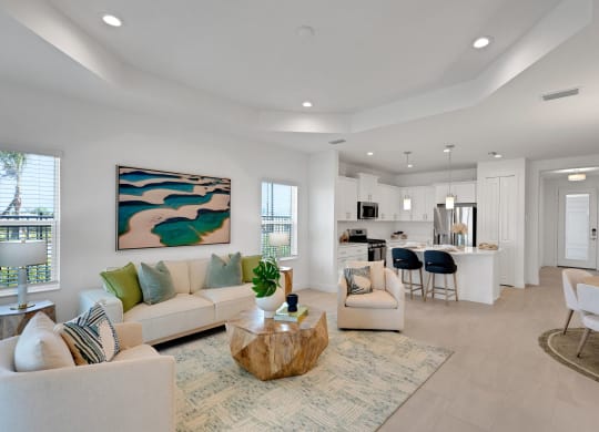 a living room with couches and a coffee table in front of a kitchen at Marisol, Florida