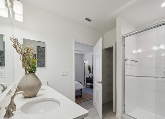 Bathroom with sink and walk-in shower in 3-bedroom model home