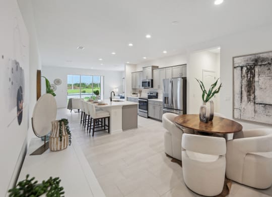 3-bedroom model townhome with dining room and kitchen with stainless steel appliances
