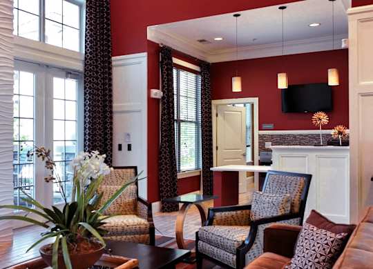 A living room with a fireplace and a painting on the wall.