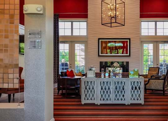 A reception area with a red carpet and a chandelier.