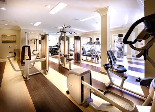 A gym with a variety of exercise equipment.