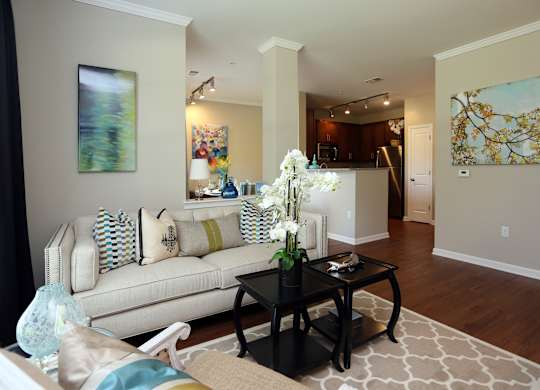 A living room with a white couch and a coffee table.