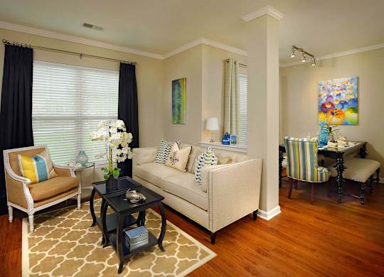 A living room with a sofa, chairs, and a coffee table.