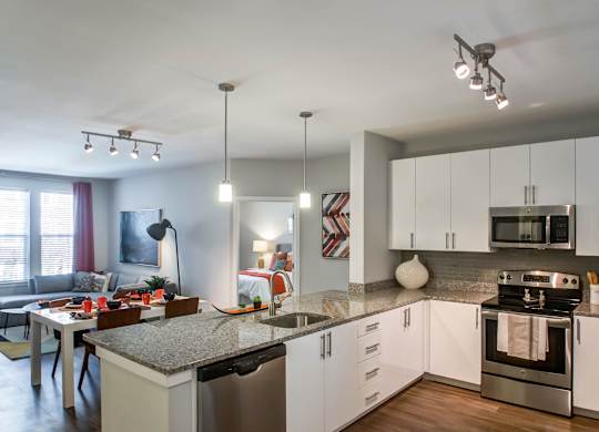 A modern kitchen with a dining table and chairs.