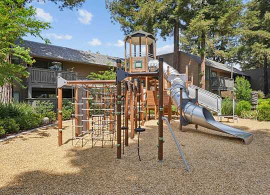 Playground with climbing structure and surrounding landscaping