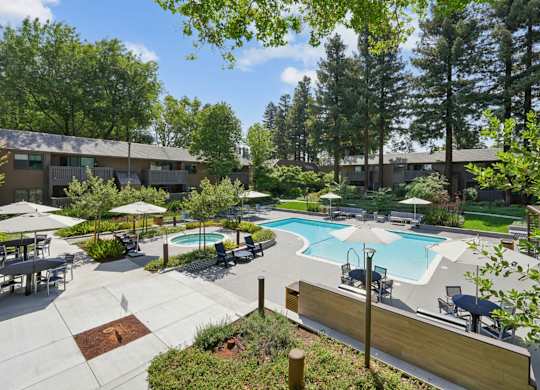 Outdoor swimming pool with landscaped surroundings at Old Orchard Apartments