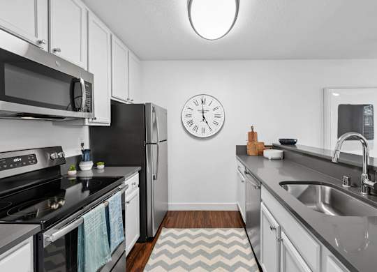 Kitchen with appliances and functional layout at Old Orchard Apartments