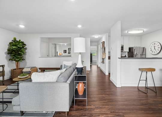 Dining area with round table, chairs, breakfast bar seating, and adjacent kitchen