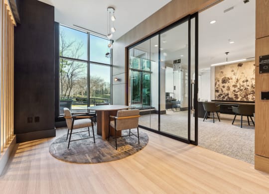a dining room with glass walls and a table and chairs