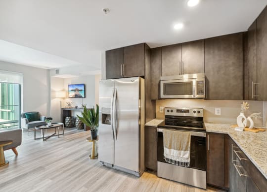 a kitchen with stainless steel appliances and marble counter tops