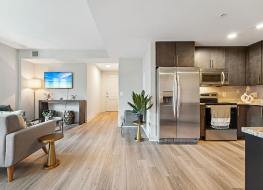A living room with a view of the kitchen