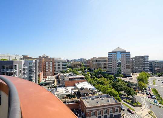 a view of the city from the balcony of a building on a sunny day