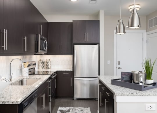 a modern kitchen with stainless steel appliances and granite counter tops