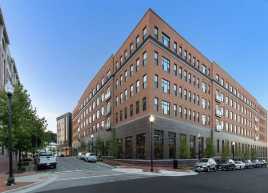 a large brick building on the corner of a city street