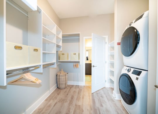 a washer and dryer in a laundry room with a closet