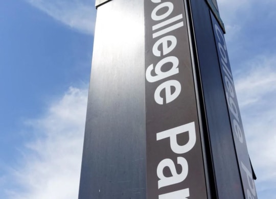 a tall sign for a shopping center