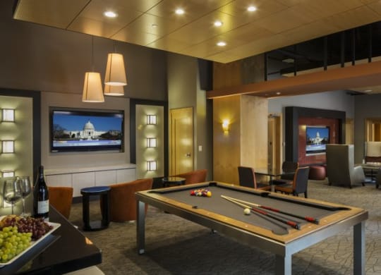 a game room with a pool table and a television