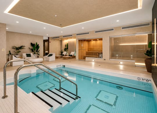 Spa featuring access to both sauna and steam room with sleek, contemporary finishes.