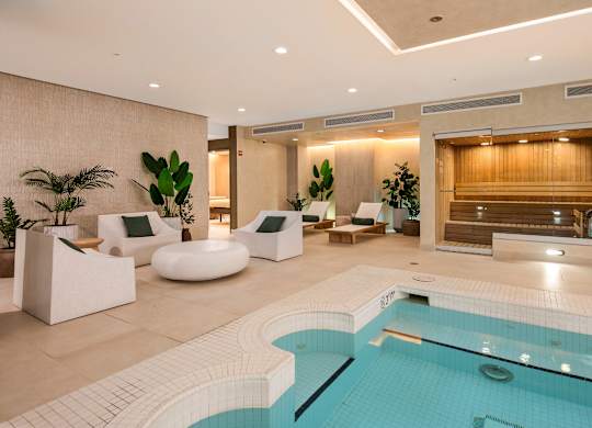 Calm spa lounge with natural materials, soft lighting, and a neutral color palette.