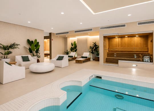 Calm spa lounge with natural materials, soft lighting, and a neutral color palette.area.