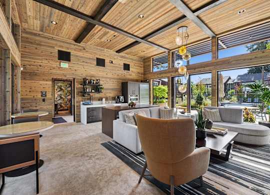 A modern living room with a wooden ceiling and furniture.