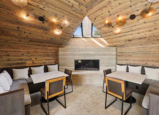 A cozy room with a fireplace and a table with chairs.