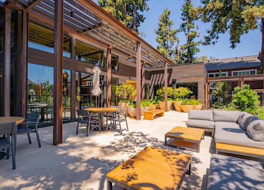 A wooden patio with a table and chairs.