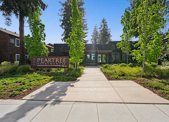 A building with a sign that says "3 PEARSTREET APARTMENTS" in front of it.