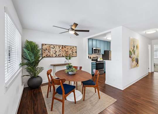 A dining room with a table set for four.