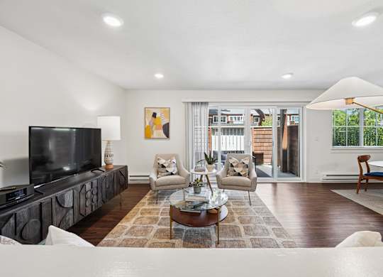 A modern living room with a flat screen TV and a coffee table.