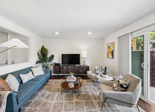 A living room with a blue couch and a coffee table.